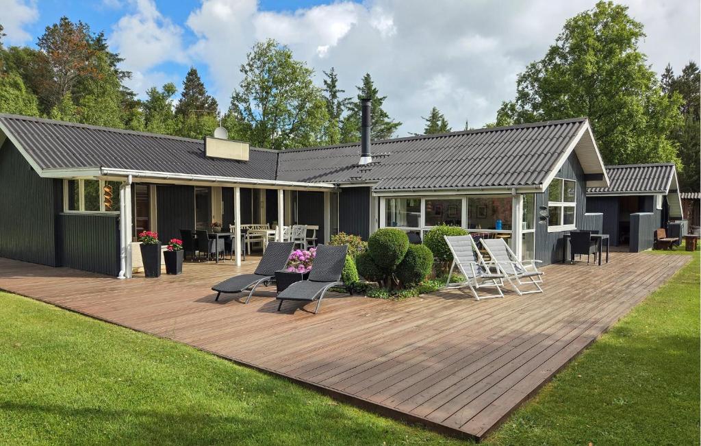 a house with a deck and chairs on it at 2 Bedroom Beautiful Home In Jerup in Jerup