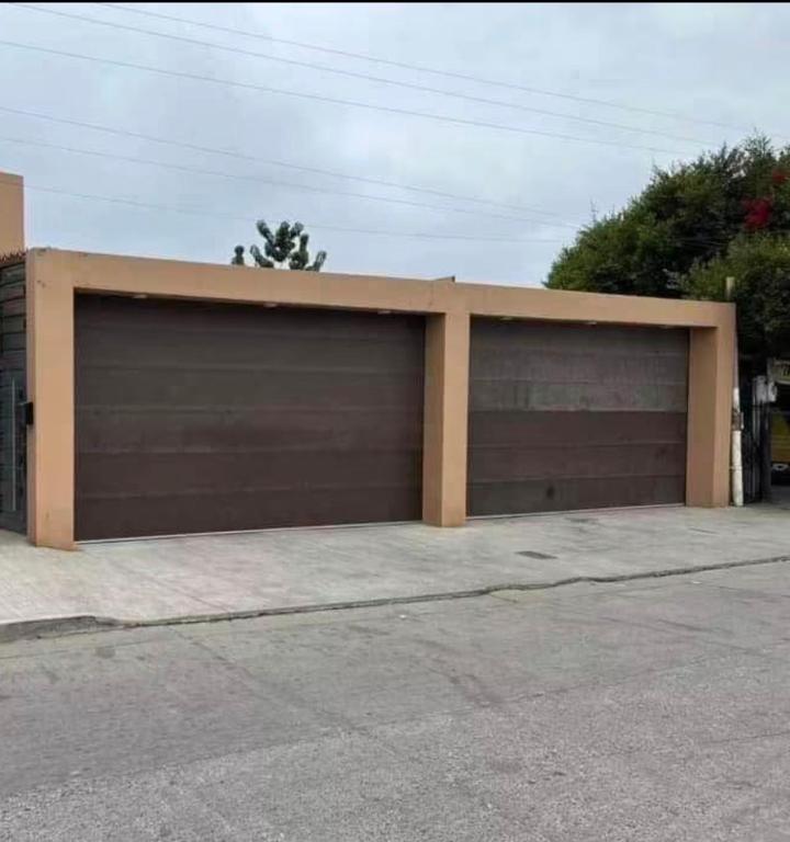 a pair of garage doors in a parking lot at CasaLyz in Rosarito Beach