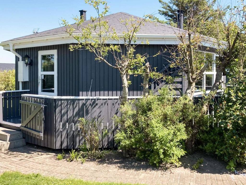 a house with a fence in front of it at 4 person holiday home in Vinderup in Vinderup
