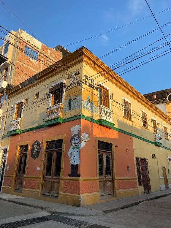 a building with a painting on the side of it at El Duke Kahanamoku surf hostel in Pacasmayo