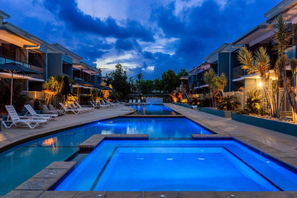 a pool at a resort at night at Ramada by Wyndham Hervey Bay in Hervey Bay