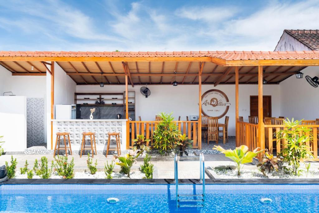 a house with a swimming pool and a patio at Arc Villas Bali in Ketewel