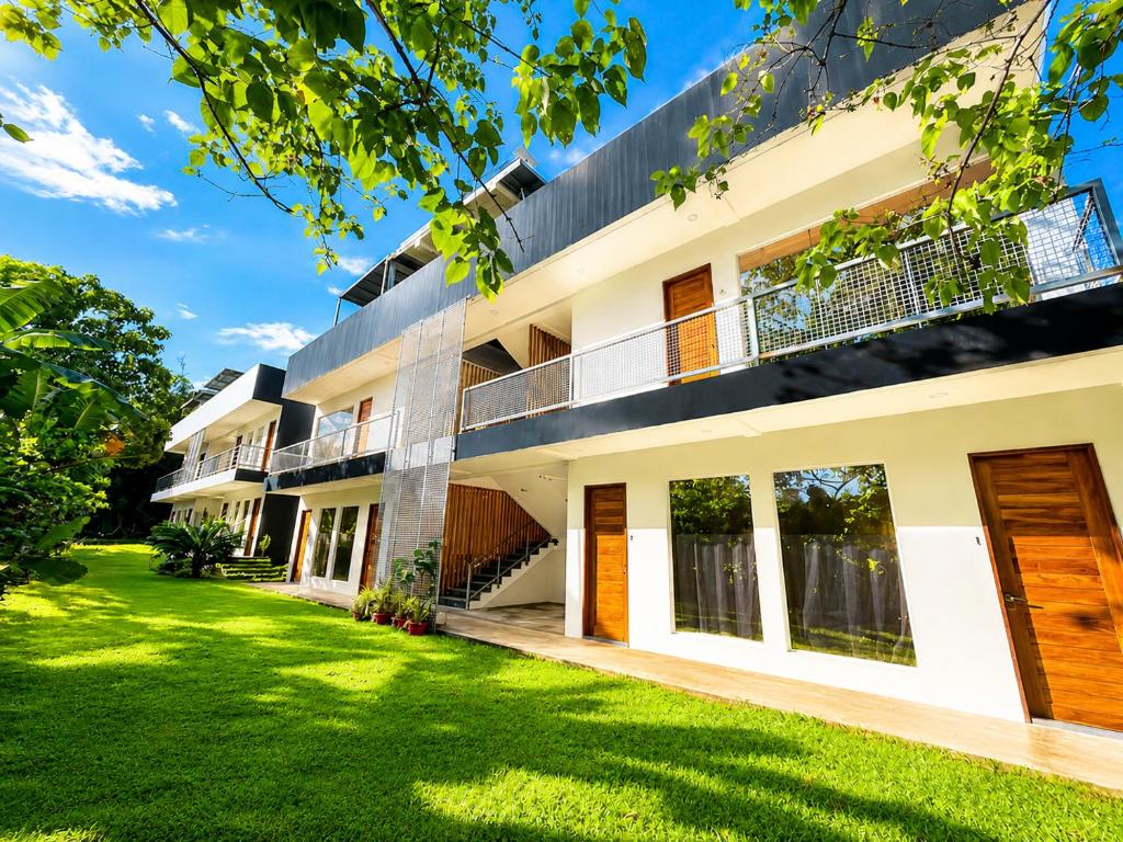 an exterior view of a building with a yard at The Ronin in General Luna