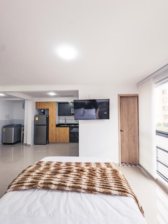 a large white room with a bed in it at Colseguros in Cali