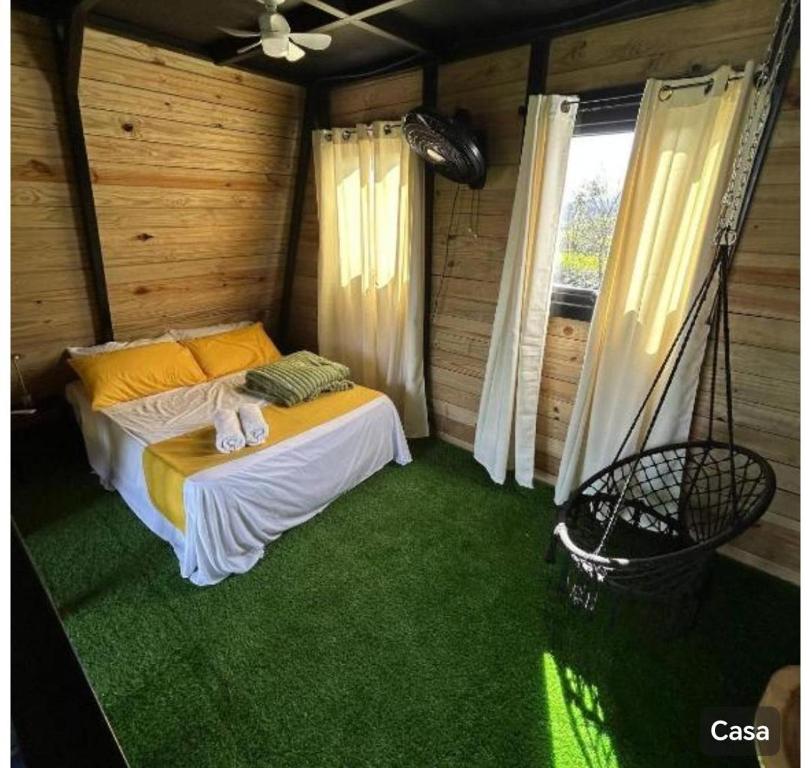 a bedroom with a bed in a room with green carpet at Villa bonita mar in Concepción de La Vega