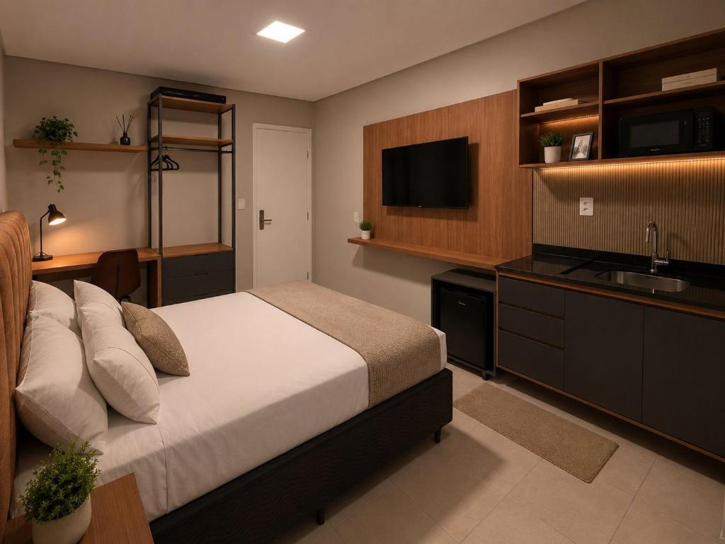 a bedroom with a bed and a sink and a television at Blume Suítes Premium Orla in Petrolina