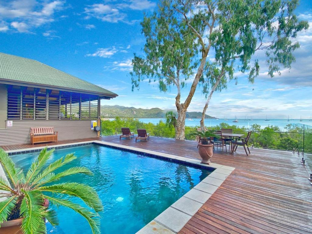 a swimming pool on a deck next to a house at Absolute Beachfront and Pool House in Horseshoe Bay