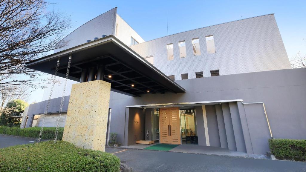 a large white building with a large entrance at ゆるり熱海withDOGS in Atami