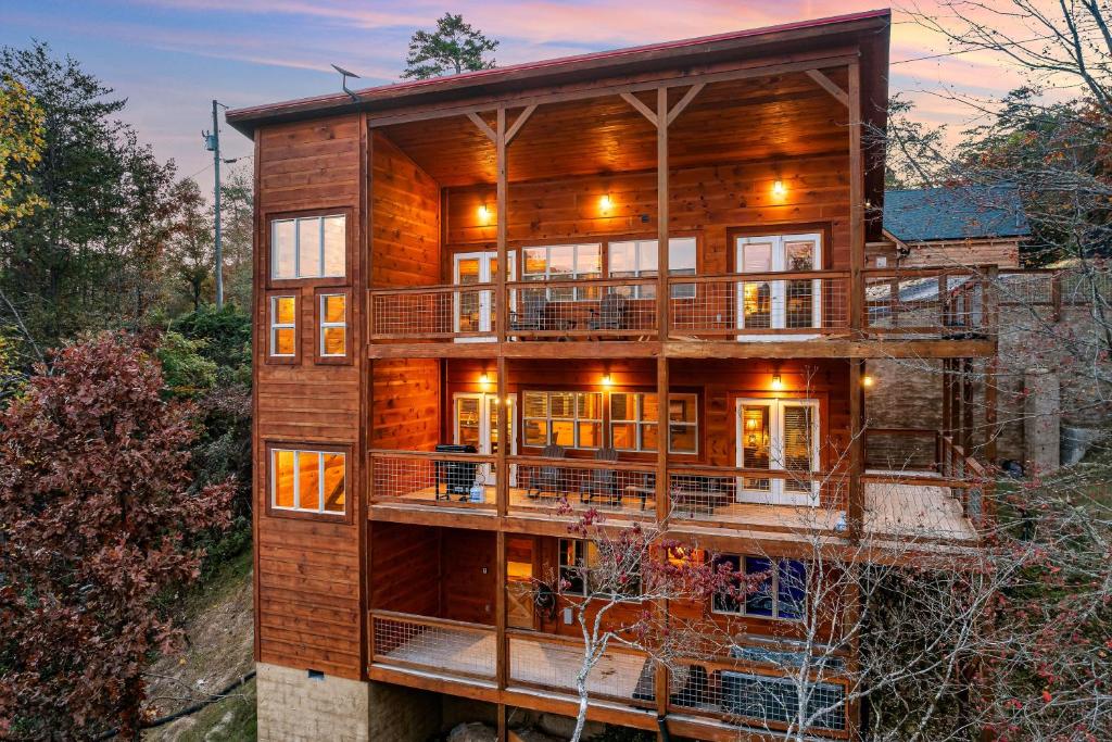 a large wooden house with a large deck at Cedar Splash in Sevierville