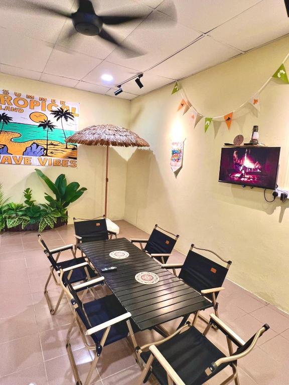 a dining room with a table and chairs and a ceiling fan at Camp Fire Homestay 2602 in Mersing