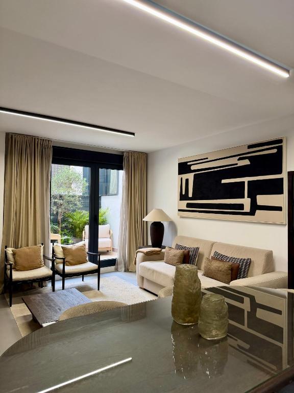 a living room with a couch and a table at Casa Amayuma - Málaga Centro Histórico in Málaga