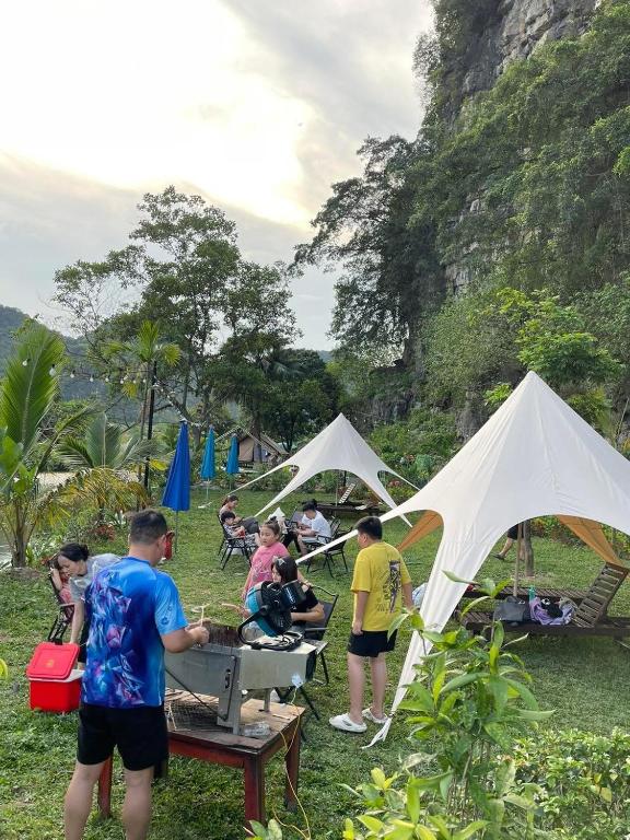 a group of people in a field with tents at Hen Camping- Coffee --------- Free if you have tent in Ninh Binh