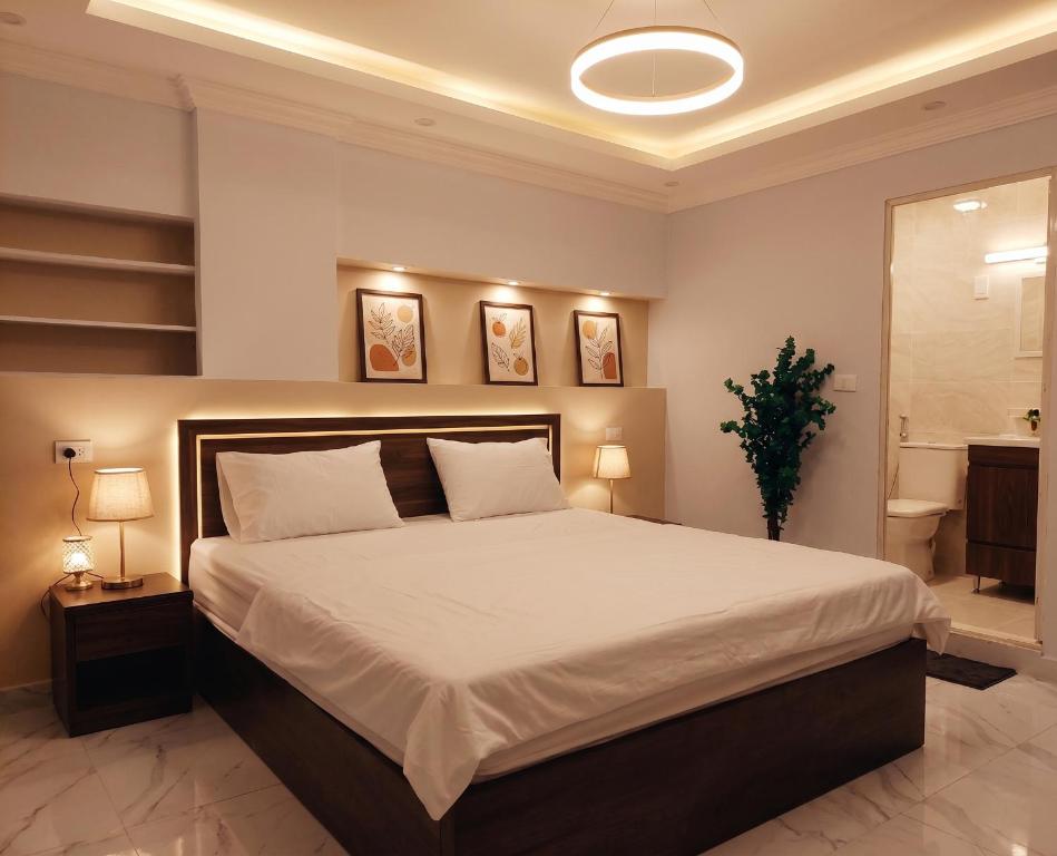a bedroom with a large bed with white sheets at Maravia downtown hotel in Cairo
