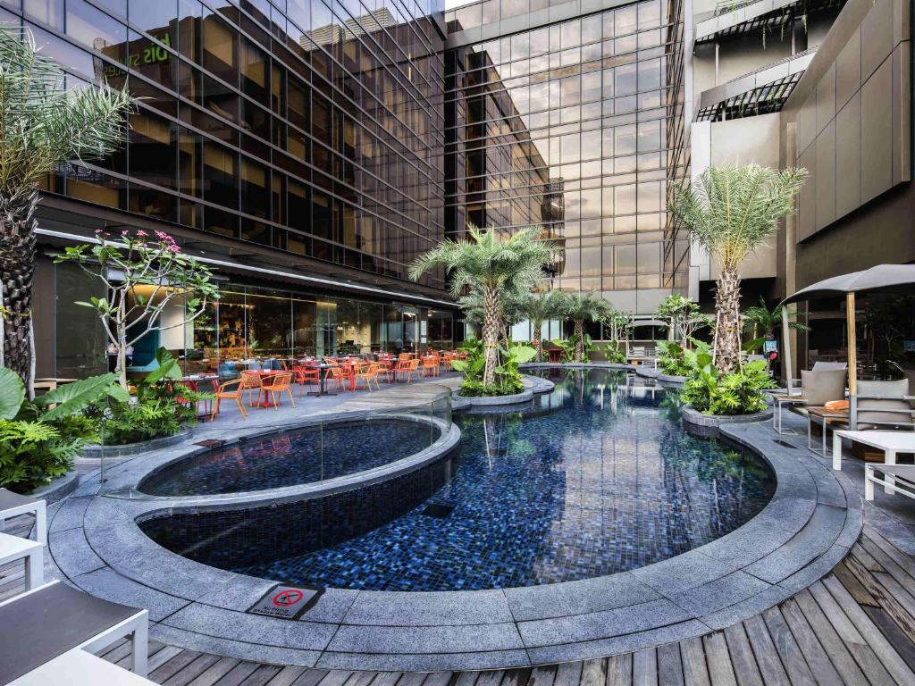 a courtyard with a pool in a building at Ibis Styles Singapore On Macpherson in Singapore