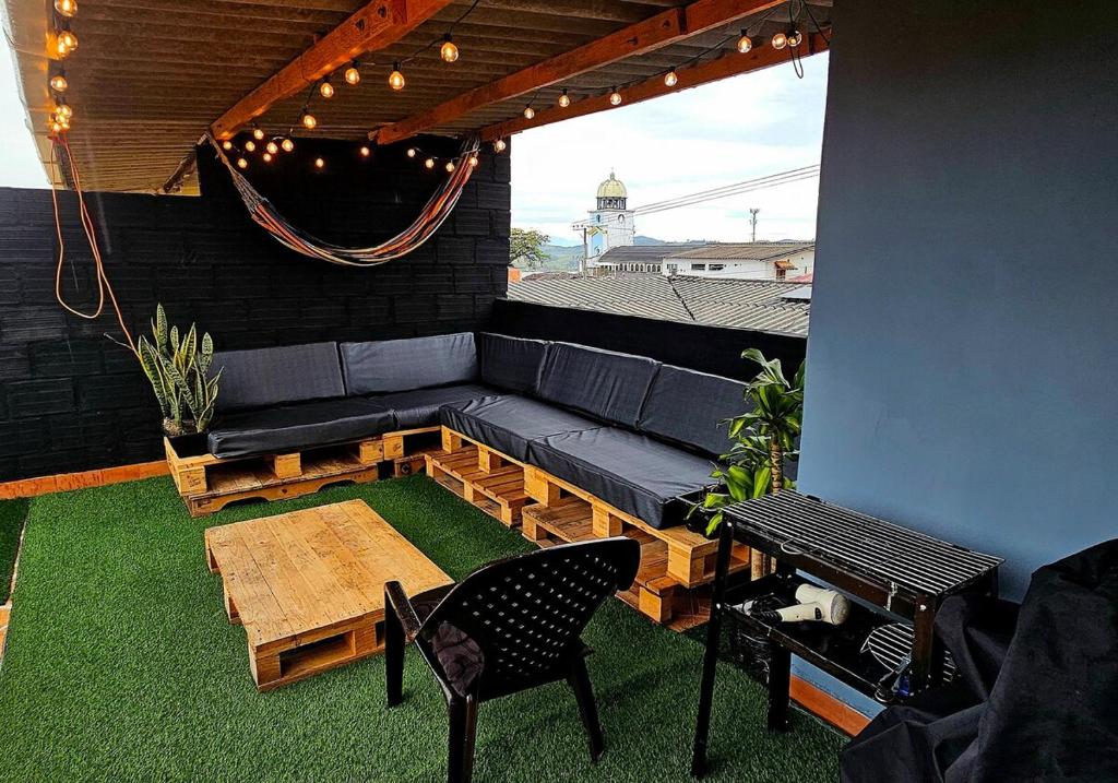 a patio with a couch and a table and a bench at Apartamento con terraza - Kalimalake in Darién