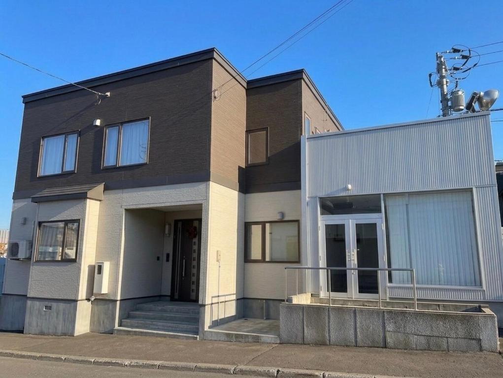 a black and white house with at Gold rich 2 in Asahikawa