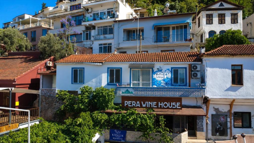 a building with a sign that reads pizza wine house at BlueTown Fethiye in Fethiye