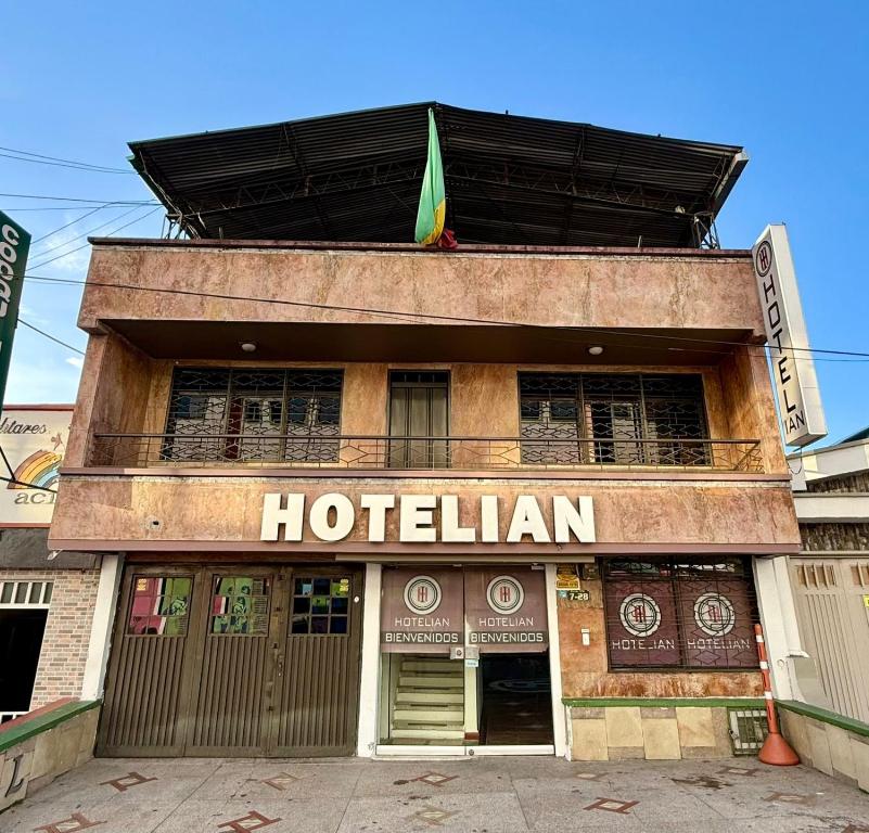 a hotel with a flag on top of a building at Hotel Iam Armenia Quindio in Armenia