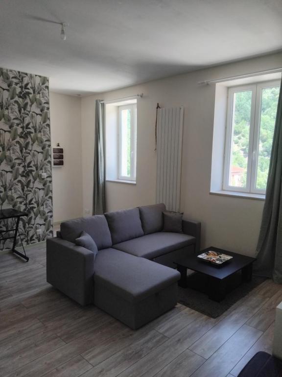 a living room with a couch and a table at Gîte Le 500 in Mayres