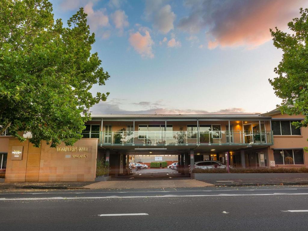 a building with a balcony on the side of a street at Mercure Orange in Orange