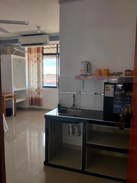 a kitchen with a black counter top in a room at Hospedaje Luciana in Pucallpa