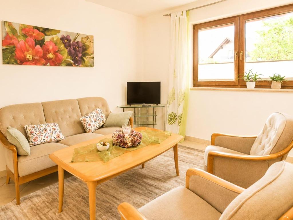 a living room with a couch and a table at Zur Kapellenwiese in Oberthal