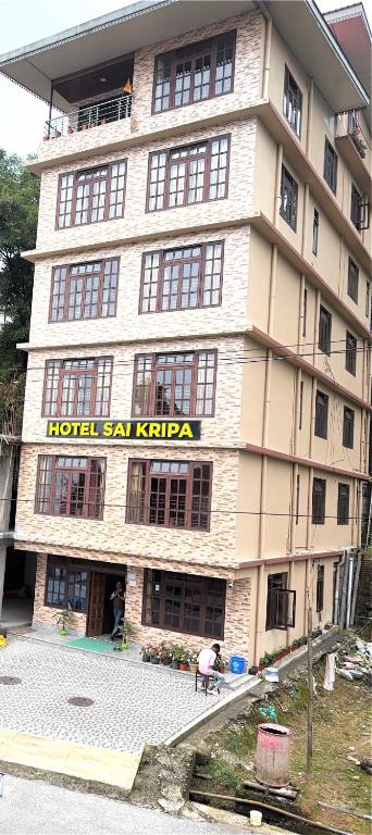 a large building with a hotel cal kittaja on it at Hotel Sai Kripa, sikkim in Ravangla