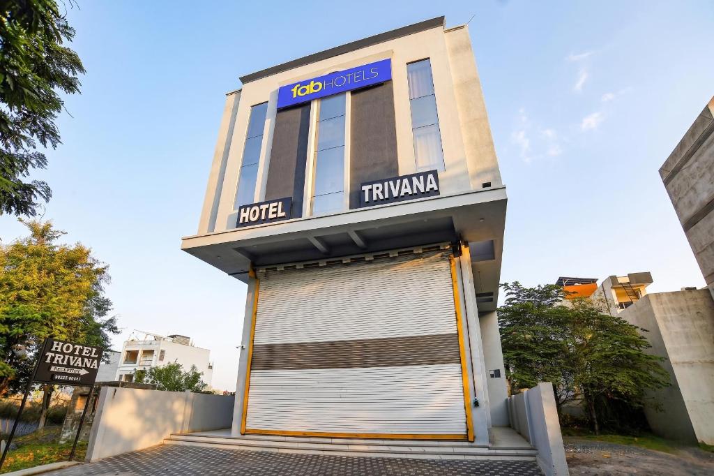 a building with a large garage door in front of it at FabHotel Trivana, Mahalaxmi Nagar in Indore