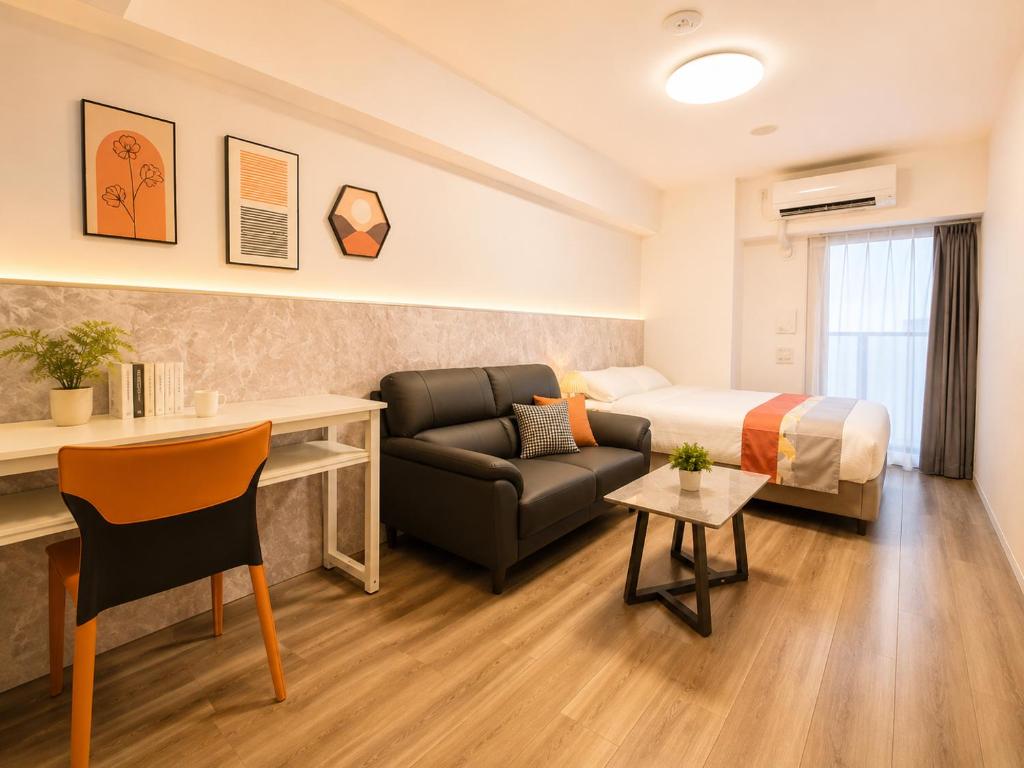 a hotel room with a bed and a couch at Hotel Arashi Tengachaya No005 in Osaka