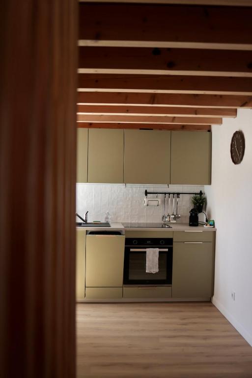 a kitchen with a sink and a stove top oven at Cozy Apartment in Pontgibaud