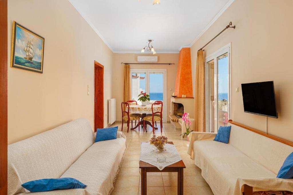 a living room with two couches and a table at Haris House in Dhaskalión