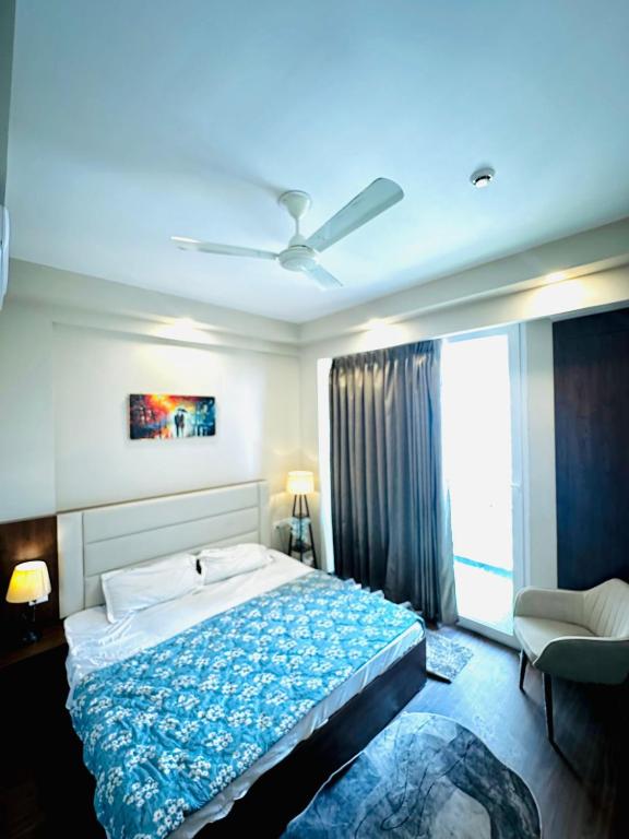 a bedroom with a large bed and a window at D Haven Stays in Greater Noida