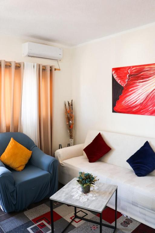 a living room with a couch and a table at Willy Apartments in Velipojë
