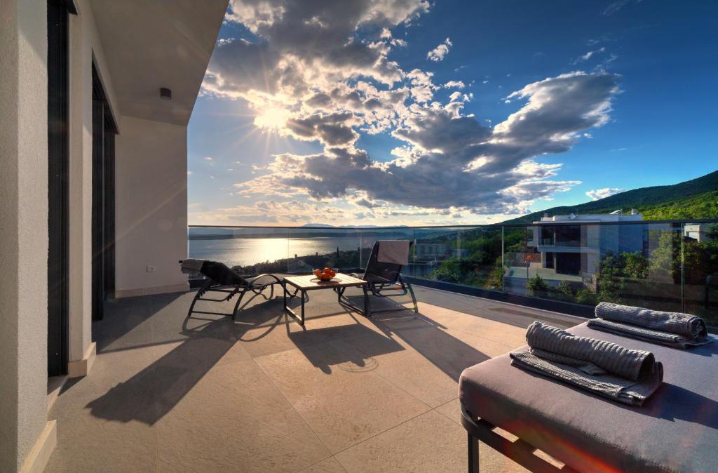 a balcony with a view of the ocean on a building at Luxurious Sea-view 3BR Apartment with Private Pool-Villa Quadris-Crikvenica in Crikvenica