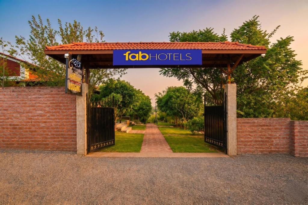a gate with a sign that reads fidoto hotels at FabHotel Nakshtra Resort in Tāsgaon