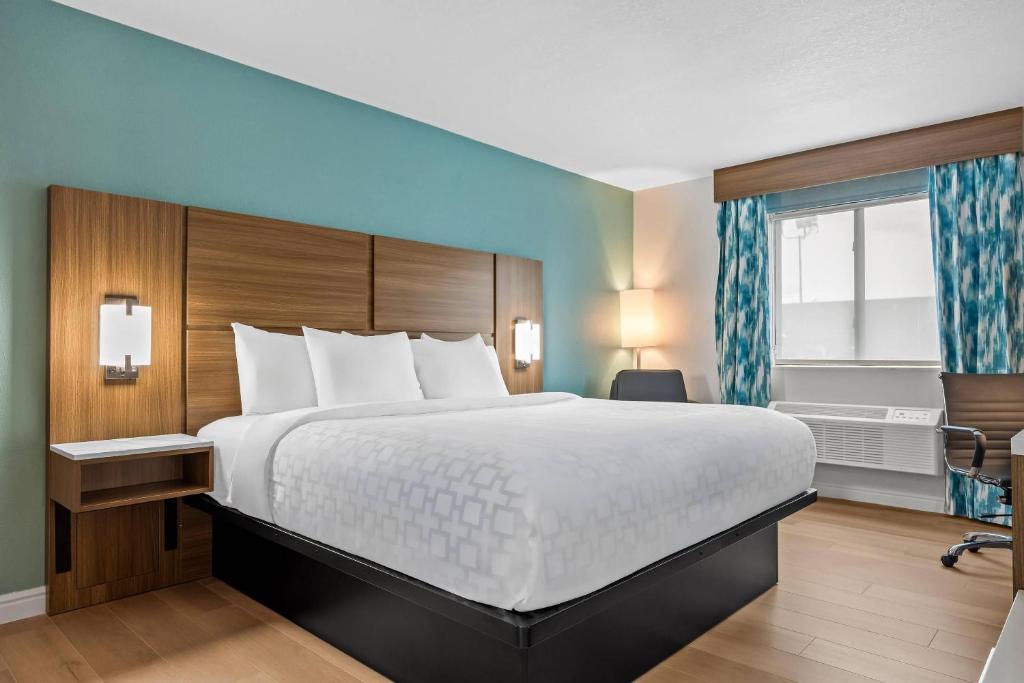 a hotel room with a large bed and a window at Clarion Pointe Springfield Southeast in Springfield