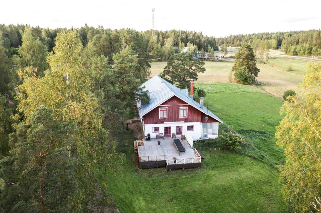 an aerial view of a red house in a field at Kivimäen Matkailutila in Masku