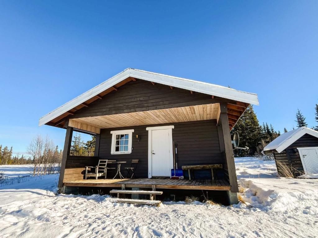 a small cabin with a porch in the snow at 4 person holiday home in gol in Gol