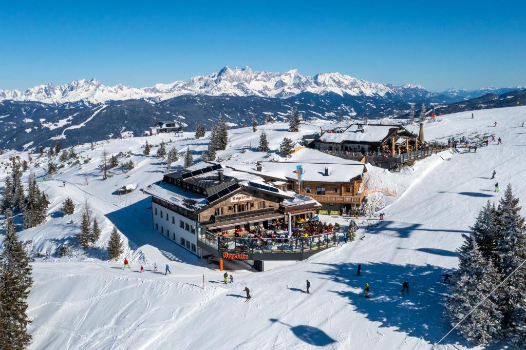 a ski lodge on a ski slope in the snow at Gasthof Kogelalm in Wagrain