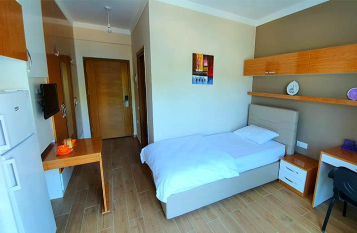 a bedroom with a bed and a desk and a bed sidx sidx sidx at yurt odası in Troulli