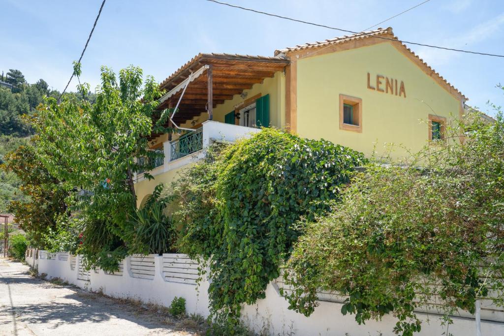 a house with ivy growing on the side of it at Lenia Studios in Kalamitsi