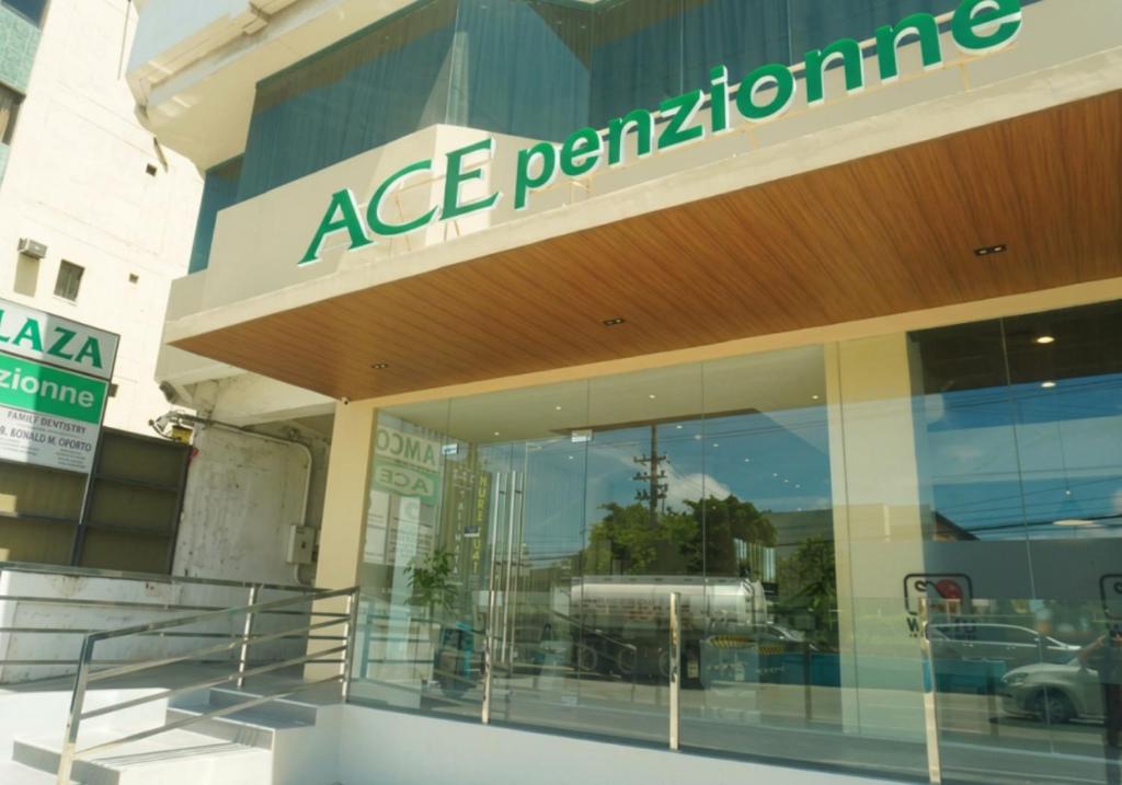a store front with a sign on the side of it at Ace Penzionne by Hiverooms in Pajo