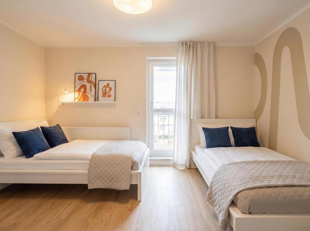 a bedroom with two beds and a window at MOWO Kornwestheim in Kornwestheim