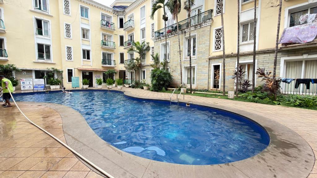 a large swimming pool in front of a building at Triyaah Pool View Studios Arpora, Goa in Arpora