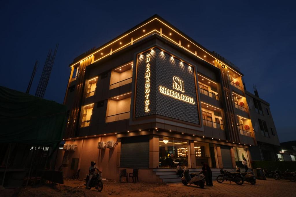 a building with lights on the side of it at Hotel Sharma Jaipur in Jaipur