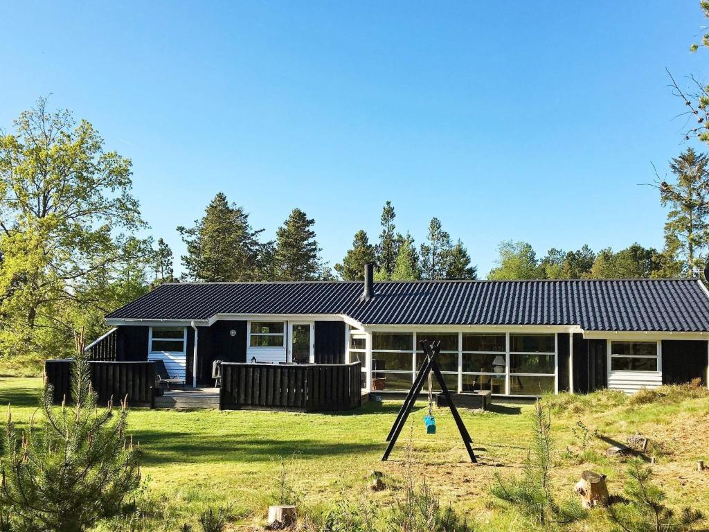 a house with a solar roof on a yard at 5 star holiday home in Jerup in Jerup