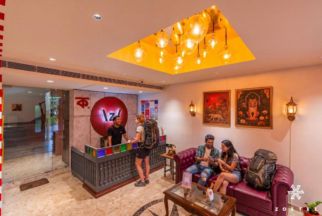 a group of people sitting in a living room at Zostel Kolkata in Kolkata