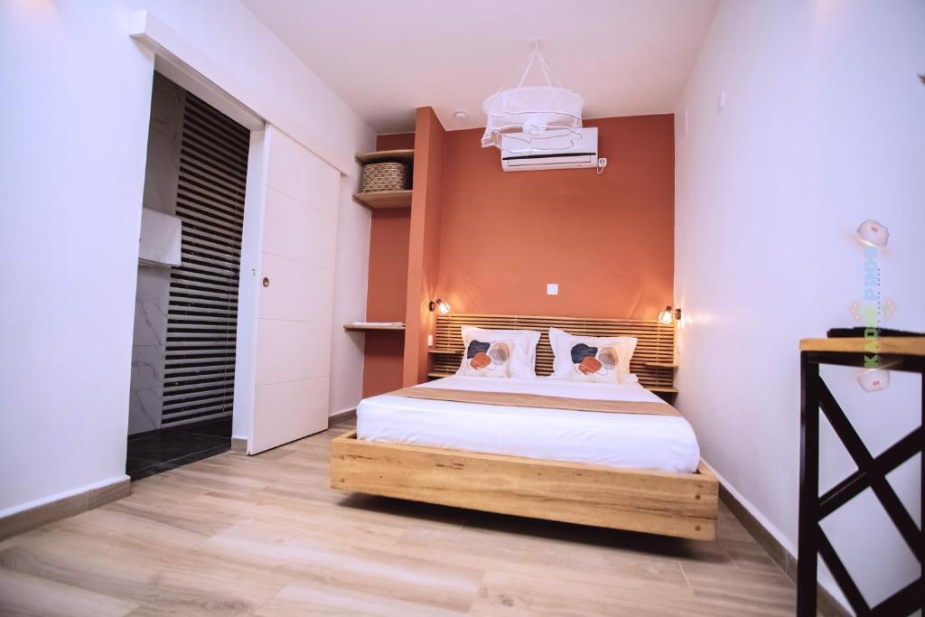 a bedroom with a bed with two dogs on it at Odyssée Résidence in Mahajanga