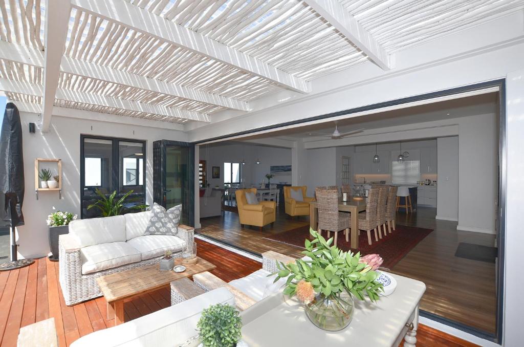 a living room with a couch and a table at Caracal 54 in Yzerfontein