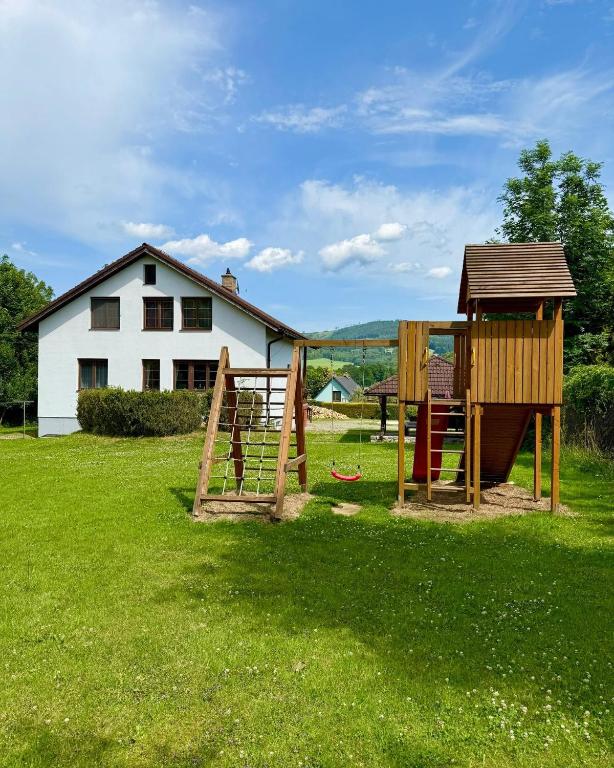a playground in a yard next to a house at Vila Bělá pod Pradědem in Bělá pod Pradědem